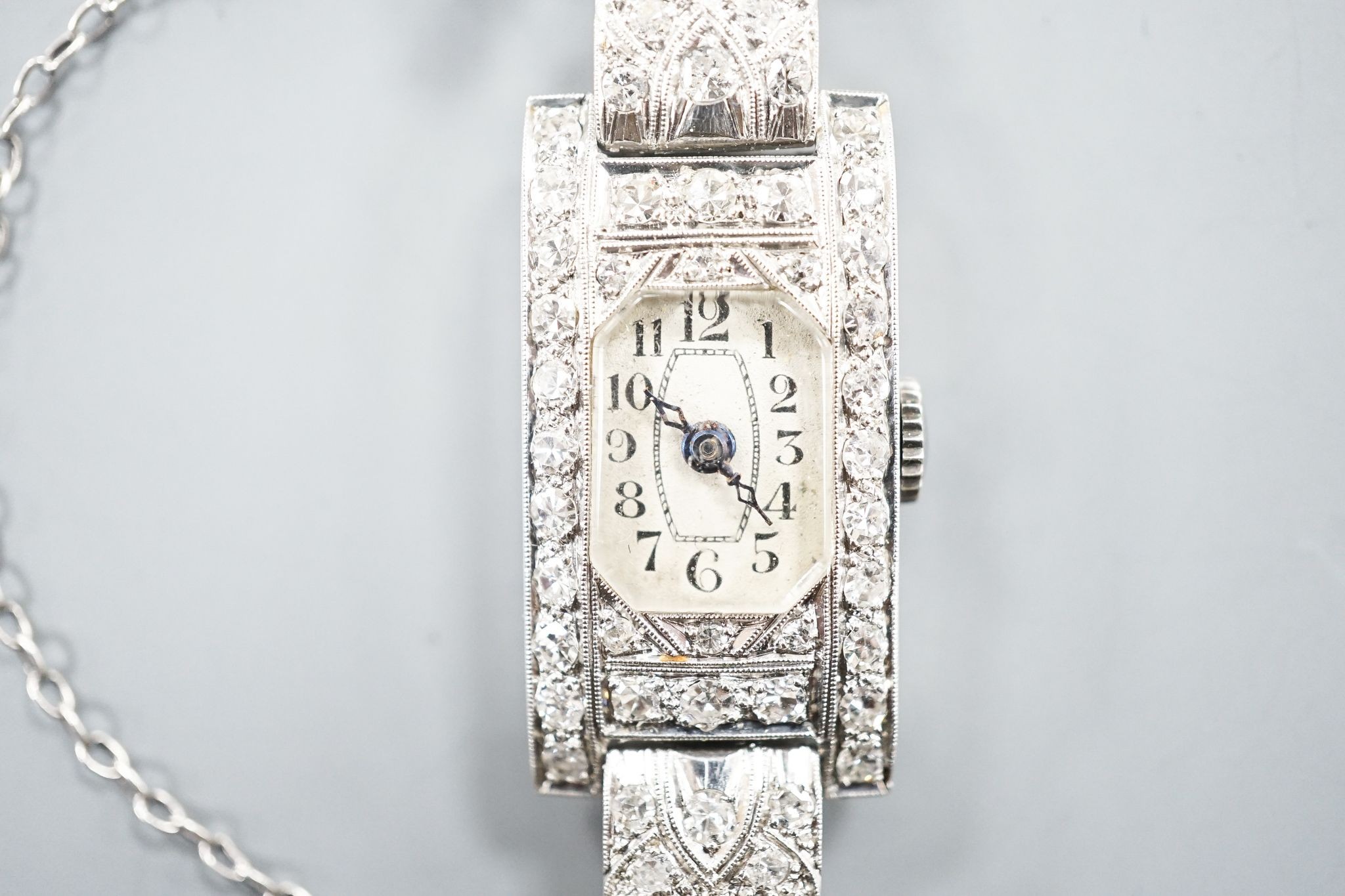 A lady's white metal (stamped platinum) and diamond set cocktail watch, the bracelet with diamond set shoulders, approx. 16cm, gross weight 23.8 grams.